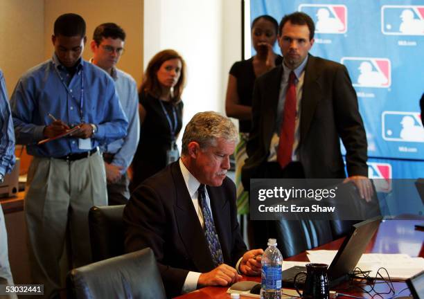 Roy Krasik , Senior Director of Major League Baseball Operations, sits at his computer during the Major League Baseball draft on June 7, 2005 at the...