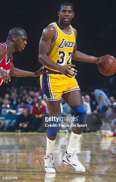 Los Angeles Lakers' Magic Johnson dribbles during a game. NOTE TO USER: User expressly acknowledges and agrees that, by downloading and/or using this...