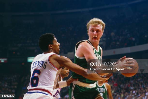 Philadelphia 76ers' forward Julius Erving defends against Boston Celtics' Larry Bird during a game at The Spectrum circa 1990 in Philadelphia,...