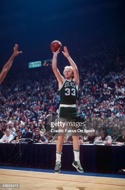 Boston Celtics' forward Larry Bird jumps and shoots from the corner against the Washington Bullets during a game at Capital Centre circa the 1980's...