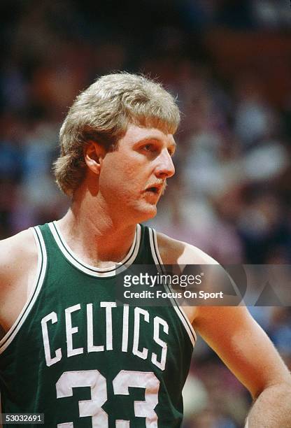 Boston Celtics' center Larry Bird stands on the court during a game. NOTE TO USER: User expressly acknowledges and agrees that, by downloading and/or...