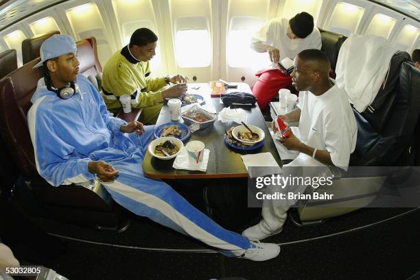 Carmelo Anthony, Rodney White, Earl Boykins and Andre Miller eat while the Denver Nuggets fly to Orlando for a game against the Orlando Magic on...