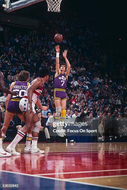 Utah Jazz's guard Pete Maravich jumps and shoots near the basket during a game against the Washington Bullets at Capital Center circa 1979 in...