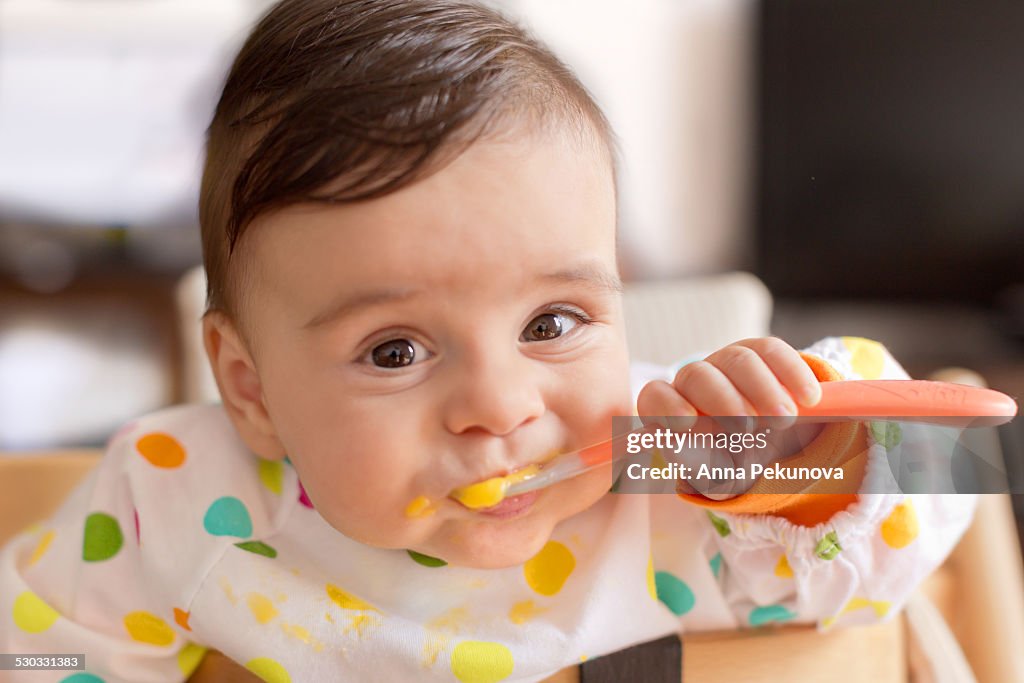 Baby boy eating pureed food
