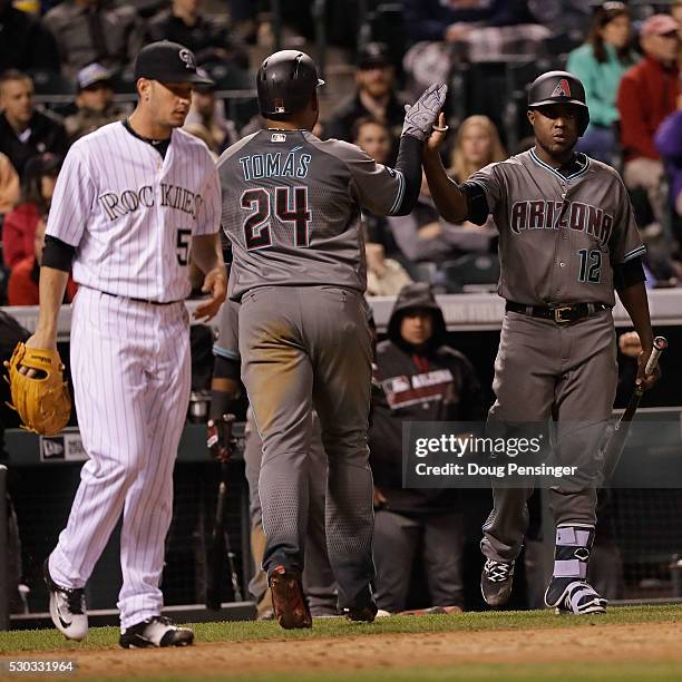 Yasmany Tomas of the Arizona Diamondbacks is congratulated by starting pitcher Rubby De La Rosa after scoring on a single by Nick Ahmed off of...