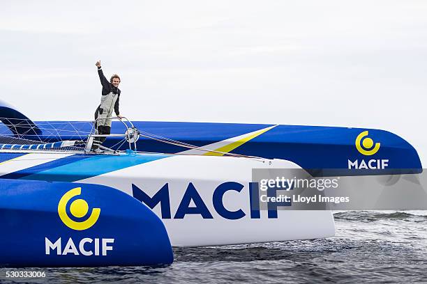 Francois Gabart on board his MACIF 105ft trimaran, celebrates after winning the 'Transat Bakerly' solo transatlantic yacht race May 10, 2016 on the...