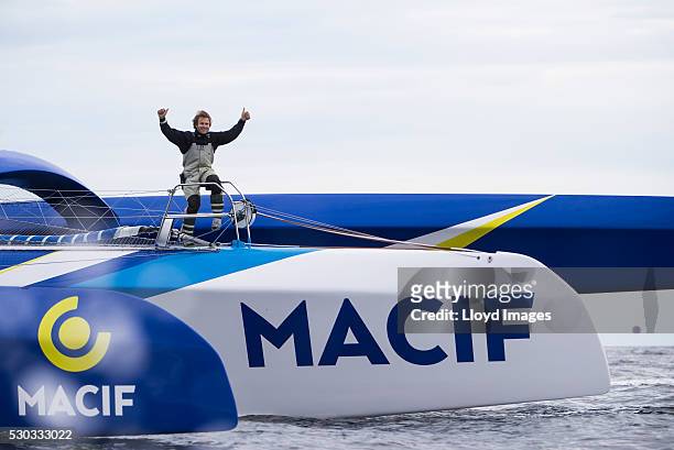 Francois Gabart on board his MACIF 105ft trimaran, celebrates after winning the 'Transat Bakerly' solo transatlantic yacht race May 10, 2016 on the...