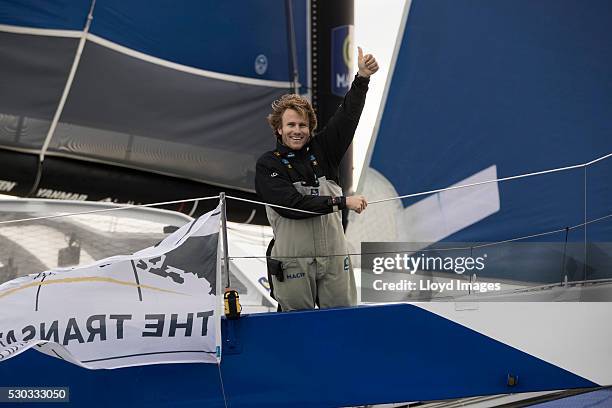 Francois Gabart on board his MACIF 105ft trimaran, celebrates after winning the 'Transat Bakerly' solo transatlantic yacht race May 10, 2016 on the...