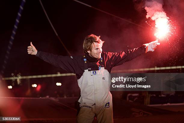 Francois Gabart on board his MACIF 105ft trimaran, celebrates after winning the 'Transat Bakerly' solo transatlantic yacht race May 10, 2016 on the...