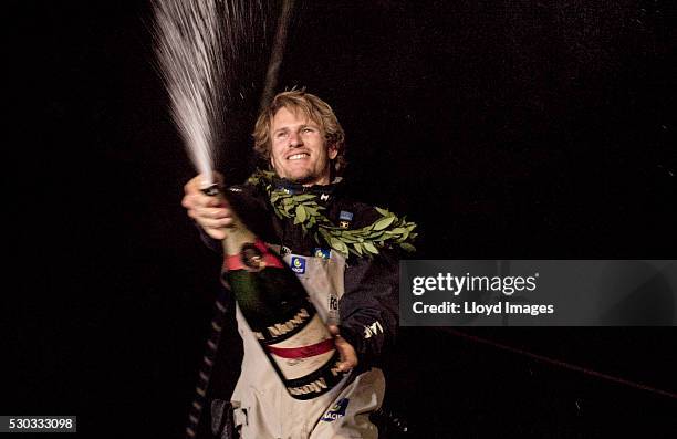 Francois Gabart on board his MACIF 105ft trimaran, celebrates after winning the 'Transat Bakerly' solo transatlantic yacht race May 10, 2016 on the...