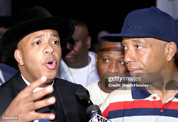 Reverend Run gestures during a backstage press conference as Russell Simmons looks on before the Hip-Hop Summit on Financial Empowerment held at the...