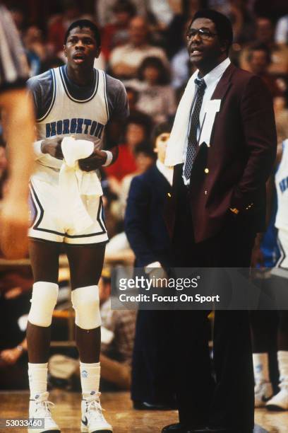 Head coach John Thompson of the Georgetown Hoyas talks with Patrick Ewing during a time out.