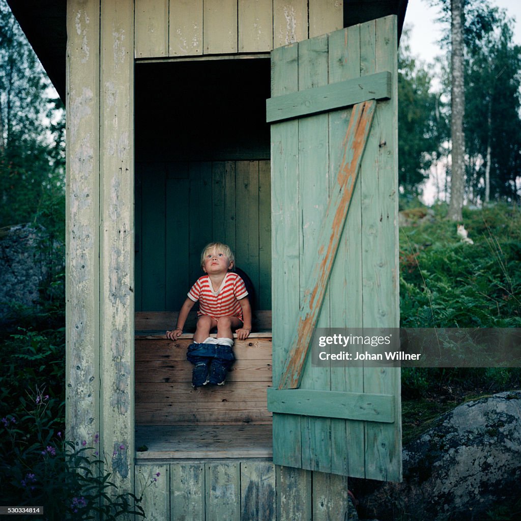 Boy in outhouse
