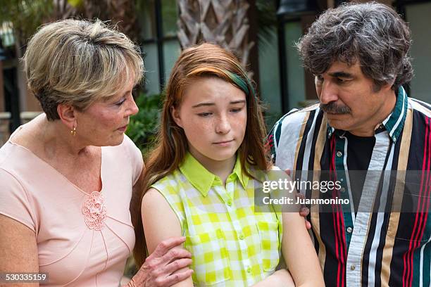 grandparents consoling their granddaughter - tienerzwangerschap stockfoto's en -beelden