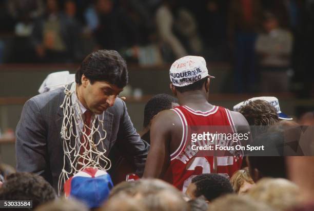 Head coach Jim Valvano of the North Carolina State Wolfpack celebrates with his team while wearing the winning net around his neck.