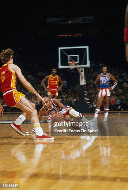 Harlem Globetrotters' Curly Neal uses his fancy dribbling techniques on the court during a game.