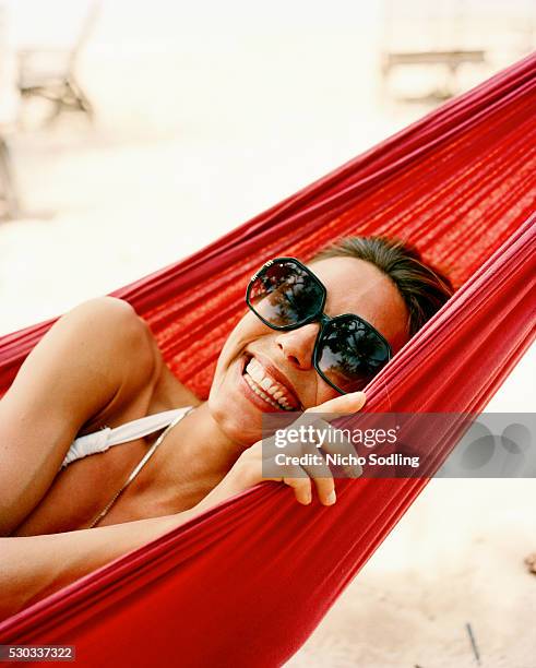 a woman in a hammock - red sunglasses stock pictures, royalty-free photos & images