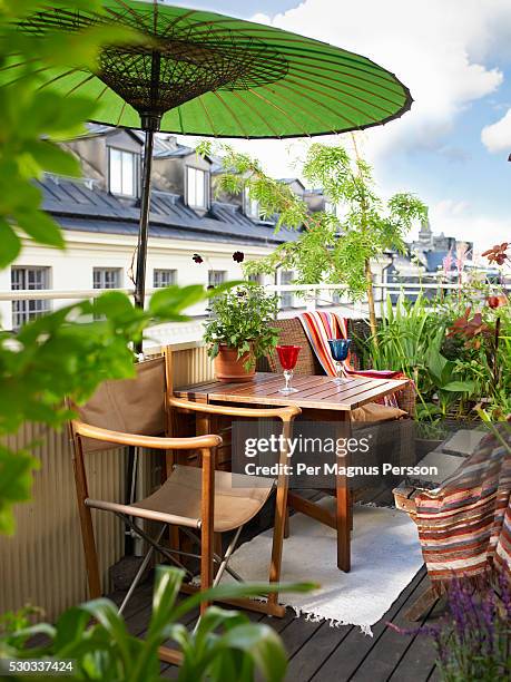 a balcony with a parasol sweden - sonnenschirm stock-fotos und bilder