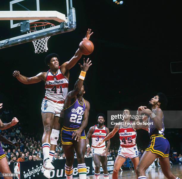 Washington Bullets' Wes Unseld jumps and blocks a shot by a Utah Jazz player during a game at Capital Centre circa the 1970's in Washington, D.C.....
