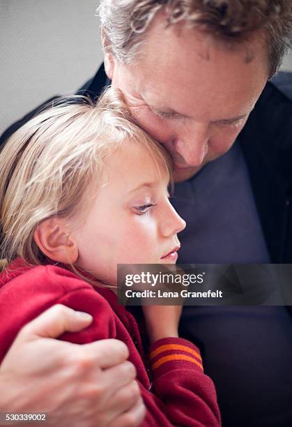 father embracing sad daughter - disappointed dad stock pictures, royalty-free photos & images