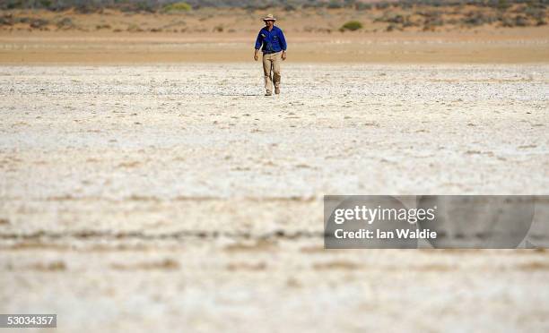 Stockman Gordon Litchfield from Wilpoorinna sheep and cattle station walks through a dried salt pan on his property June 7, 2005 in Leigh Creek,...