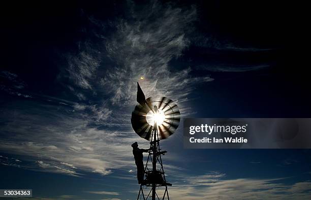 Stockman Gordon Litchfield from Wilpoorinna sheep and cattle station checks a windmill on his property June 7, 2005 in Leigh Creek, Australia....