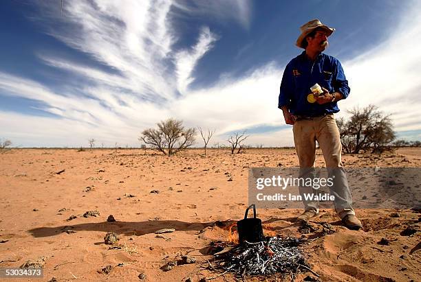 Stockman Gordon Litchfield from Wilpoorinna sheep and cattle station waits for his billy to boil on his property June 7, 2005 in Leigh Creek,...