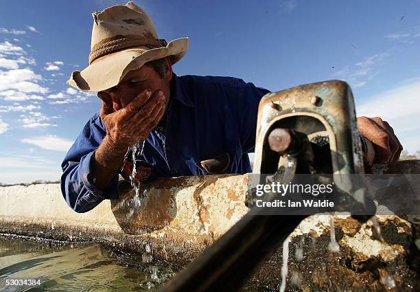 Stockman Gordon Litchfield from Wilpoorinna sheep and cattle station drinks water from a bore on his property June 7, 2005 in Leigh Creek, Australia....