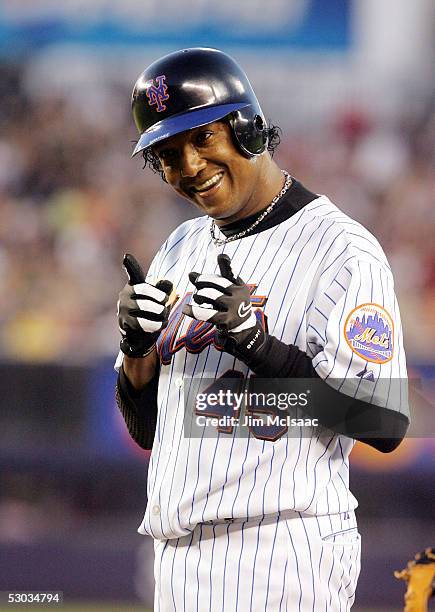 Pedro Marftinez of the New York Mets points back to his dugout after getting a base hit in the fifth inning against the Houston Astros on June 7,...