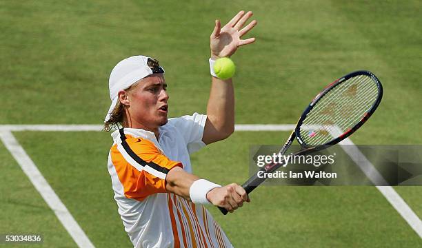 Lleyton Hewitt of Australia plays a backhand during his first round match against Xavier Malisse of Belgium at the Stella Artois Tennis Championships...