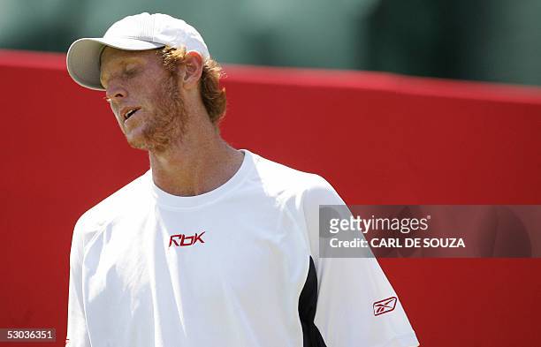 London, UNITED KINGDOM: Australian tennis player Chris Guccione reacts to missing a shot during his match against Russian player Igor Andereev at...