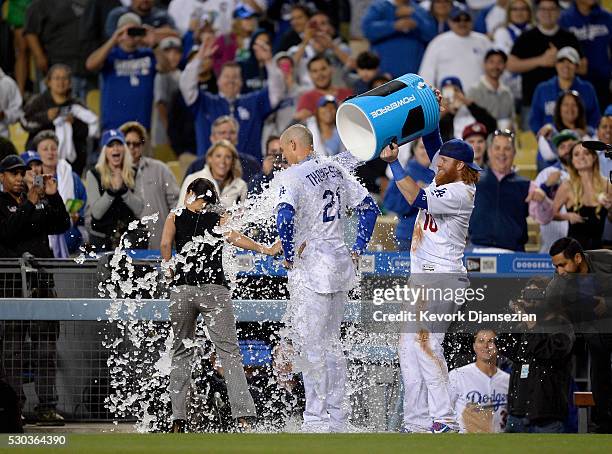 Justin Turner of the Los Angeles Dodgers celebrate as he pours ice water on Trayce Thompson of the Los Angeles Dodgers after he it the game winning...