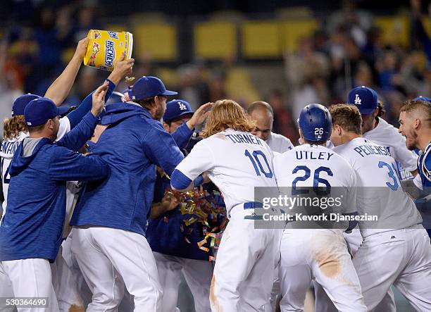 Trayce Thompson of the Los Angeles Dodgers is mobbed by his teammates after hitting the game winning pinch hit one-run home run to defeat the New...