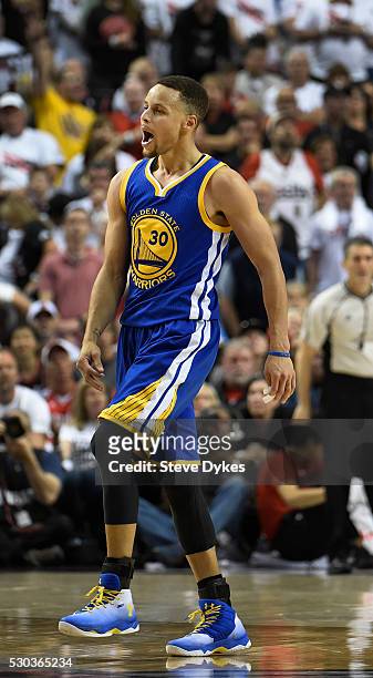Stephen Curry of the Golden State Warriors reacts after hitting a shot during overtime of Game Four of the Western Conference Semifinals against the...