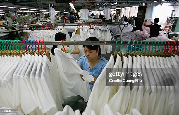 Laborers work at the Youngor Group textile factory on June 8, 2005 in Ningbo, Zhejiang Province, China. Peter Mandelson, EU trade chief, is heading...