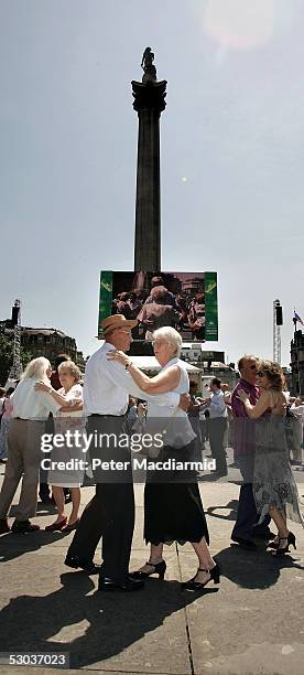 Couples take part in a mass open air tea dance in Trafalgar Square on June 8, 2005 in London. 196 pairs of dancers took part in a bid to break the...