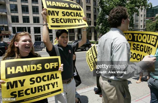 Demonstrators shout slogans and hold posters as they protest against U.S. President George W. Bush's plans on reforming the Social Security System...