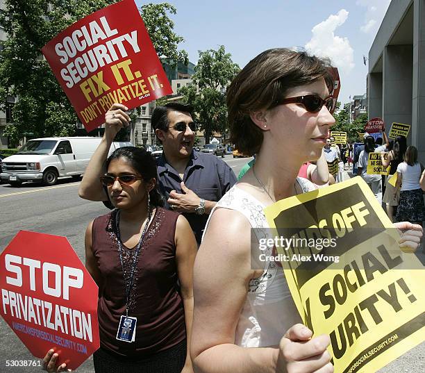 Demonstrators shout slogans and hold posters as they protest against U.S. President George W. Bush's plans on reforming the Social Security System...