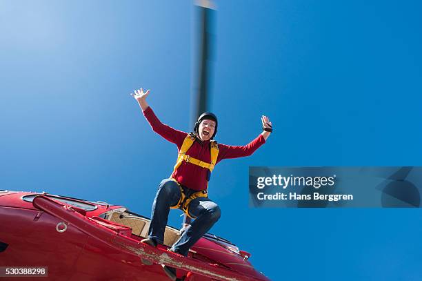 female skydiver jumping from helicopter - guess jeans ストックフォトと画像
