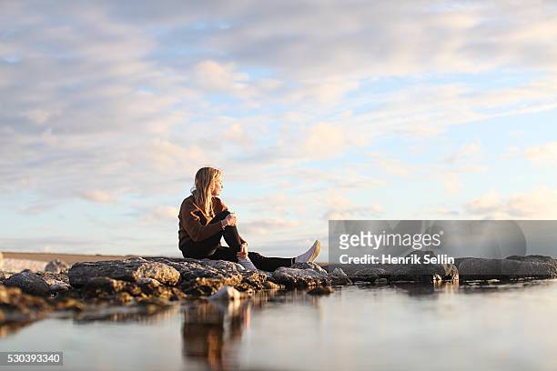 woman looking at view, faro, gotland, sweden - sitting on a cloud stock pictures, royalty-free photos & images