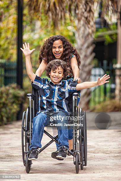 freedom in a wheelchair - boy gift stockfoto's en -beelden