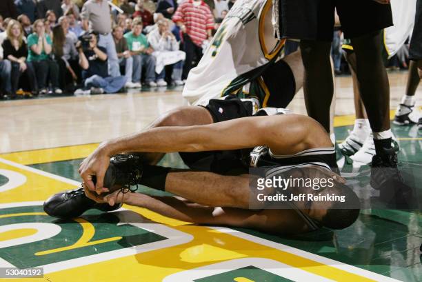 Tim Duncan of the San Antonio Spurs lies after hurting himself against the Seattle SuperSonics in Game 6 of the Western Conference Semifinals during...