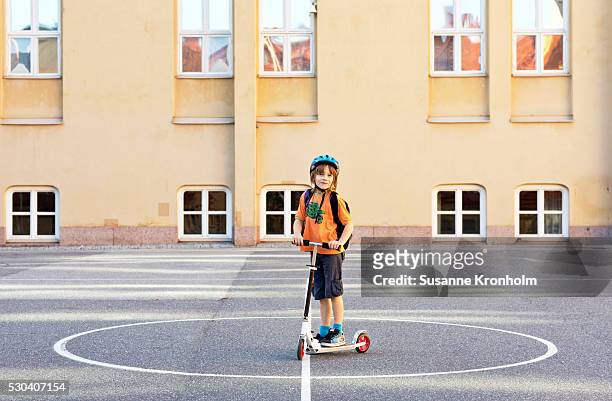 boy with kick scooter on schoolyard, stockholm, sweden - school yard stock pictures, royalty-free photos & images