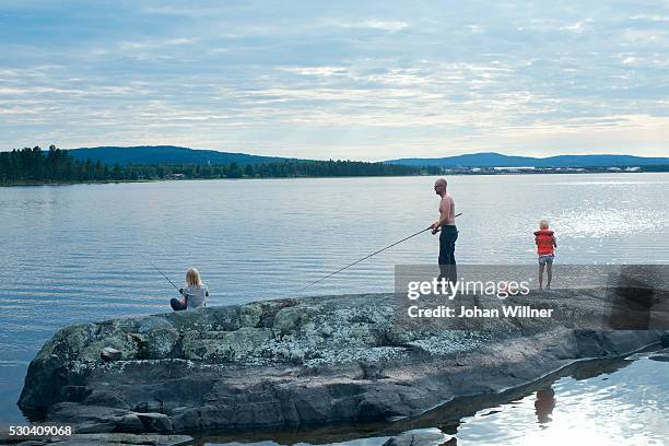 father with children fishing in lake, siljan, dalarna, sweden - dalarna stock pictures, royalty-free photos & images