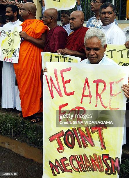 Sri Lankan left wing activists amd monks hold banners and placards as they take part in a demonstration in the suburb of Maharagama in Colombo, 09...