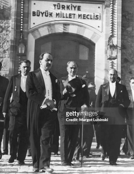 Turkish president Kemal Ataturk leaves the Grand National Assembly in Ankara with Persian Foreign Minister Firughi Khan, after signing a treaty of...