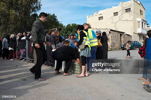 breakfast line in souda refugee camp on greek island chios - quiosque stock pictures, royalty-free photos & images