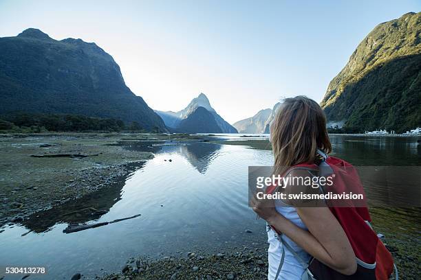woman hiking in milford sound, new zealand - milford sound stock pictures, royalty-free photos & images