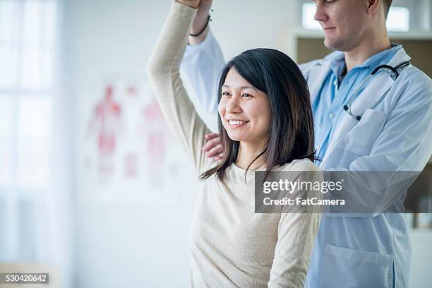 feeling better after an injury - physiotherapy asian stock pictures, royalty-free photos & images