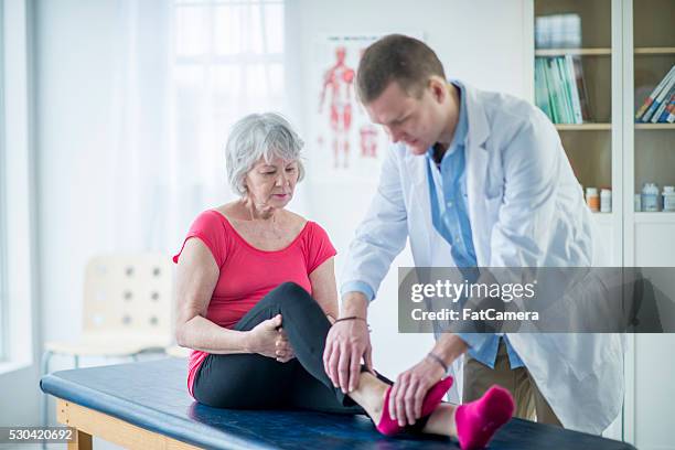 senior woman working with a physical therapist - ankle stock pictures, royalty-free photos & images